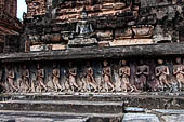 Thailand, Old Sukhothai - Wat Mahathat, stucco frieze runs around the base of the main chedi, it depicts a processions of monks with hands clasped in prayer. 